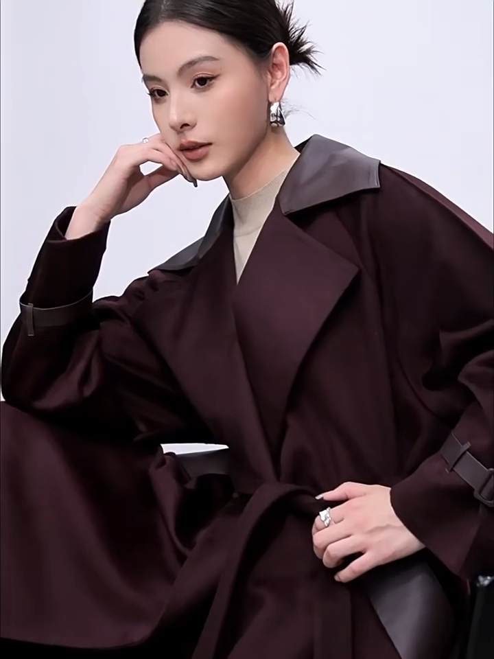 Video showcasing a Women's wrap flared wool coat in deep Bordeaux with sheepskin upper collar and architectural cuff details. — From Borcelleclothes.