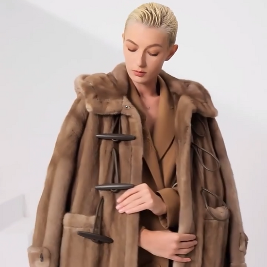 Video showcasing a Women’s sheared mink coat in Dreamcatcher color with a flared silhouette, generous hood, leather toggle details, and a mid-calf length — From Borcelleclothes.