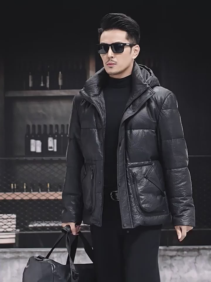 Video showcasing a Men’s compressed sheepskin down jacket in Onyx, with curved side patch pockets, decorative zippers, and sculptural collar-hood design.  —  From Borcelleclothes.