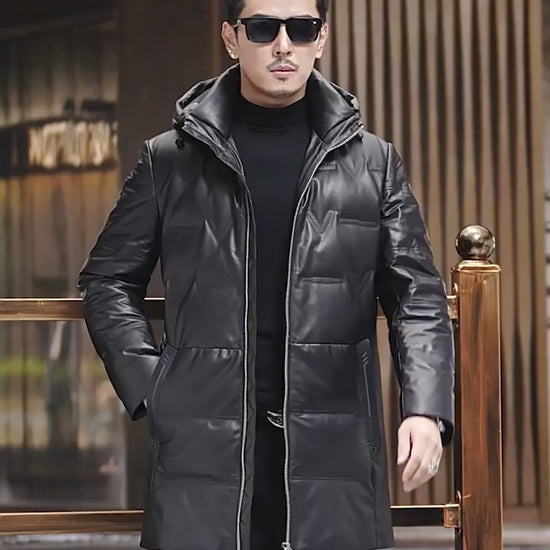 Video showcasing a Men’s down coat in embossed cowhide leather, Onyx color. Hood with drawcord and metal puller, geometric pocket details, structured silhouette — From Borcelleclothes.