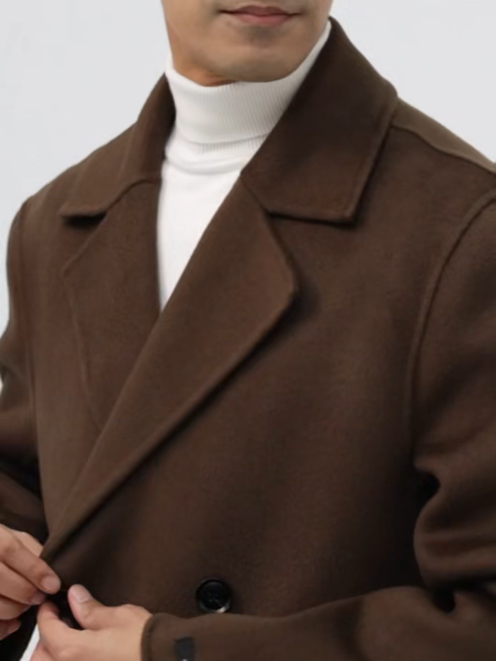 Video showcasing a Men’s double-faced wool coat in Espresso with notch lapels, double-breasted front, and hand-finished seams—crafted for quiet strength and lasting warmth. From Borcelleclothes.