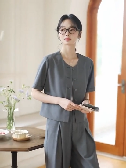 Video showcasing a Women's two-piece set in Fiord grey-blue — features a short five-button jacket and wide-leg trousers with crossed front pleats, crafted in fluid, softly textured fabric. From Borcelleclothes.