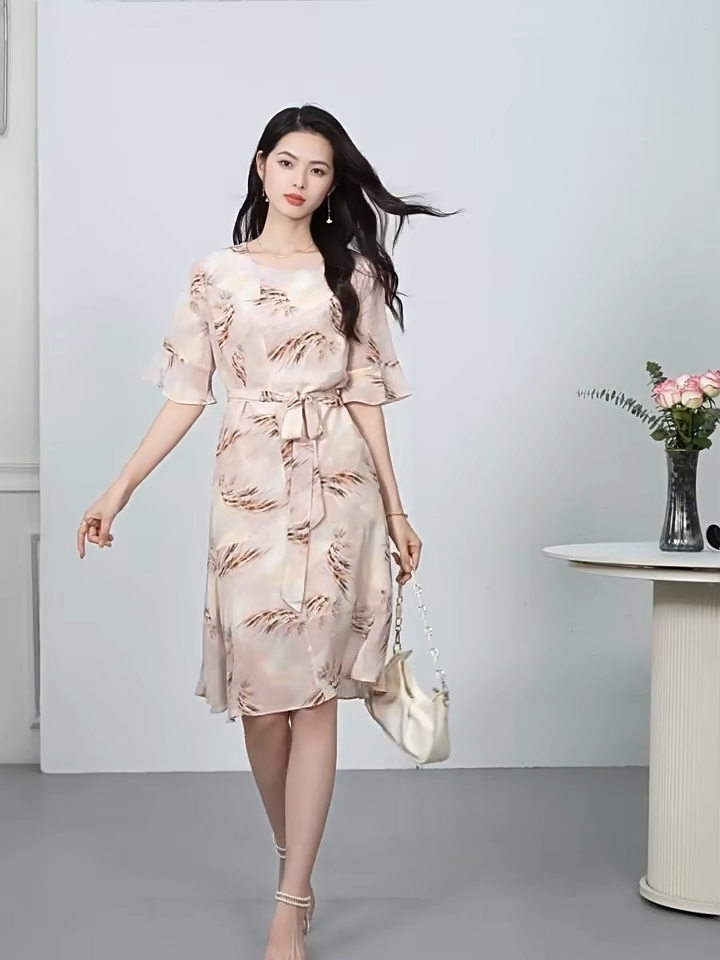 Video showcasing a Women's 100% Mulberry silk dress in First Light color with asymmetrical flounce details and fluttering sleeves. — From Borcelleclothes.