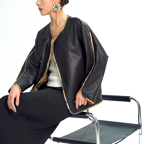 Video showcasing a Women's Reversible Nappa Sheepskin jacket featuring a sumi-e inspired watercolor print, fluid kimono sleeves, bound edges, and an asymmetric crossover front. — From Borcelleclothes.