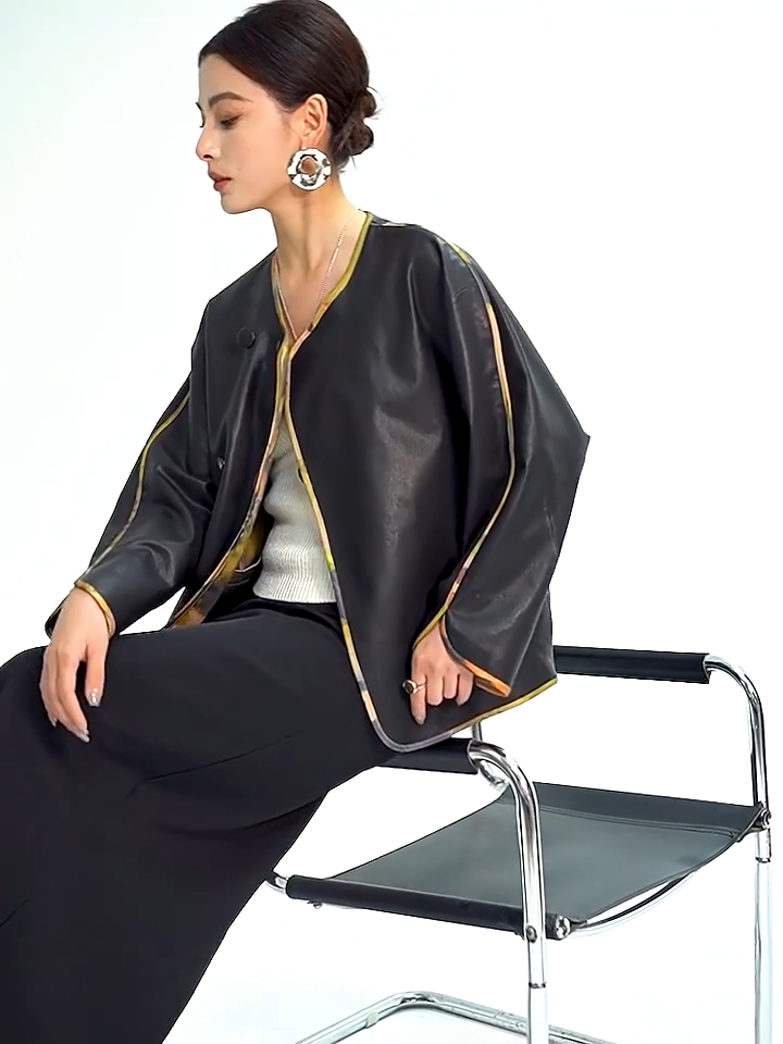 Video showcasing a Women's Reversible Nappa Sheepskin jacket featuring a sumi-e inspired watercolor print, fluid kimono sleeves, bound edges, and an asymmetric crossover front. — From Borcelleclothes.