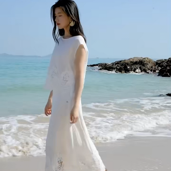 Video showcasing a Women's two-piece set featuring a cropped sleeveless top with a pearl button closure and a mid-calf A-line skirt. — From Borcelleclothes.