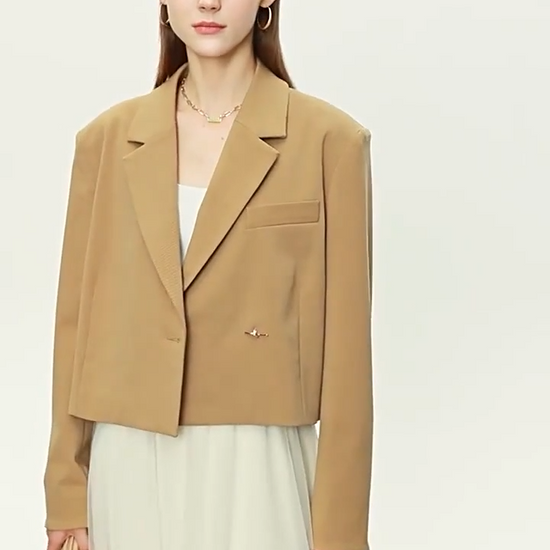 Video showcasing a Women’s Wire Knot Detail Blazer in French Beige and Onyx, with notch lapels, decorative wire-knot buttons, and precise tailoring. From Borcelleclothes.