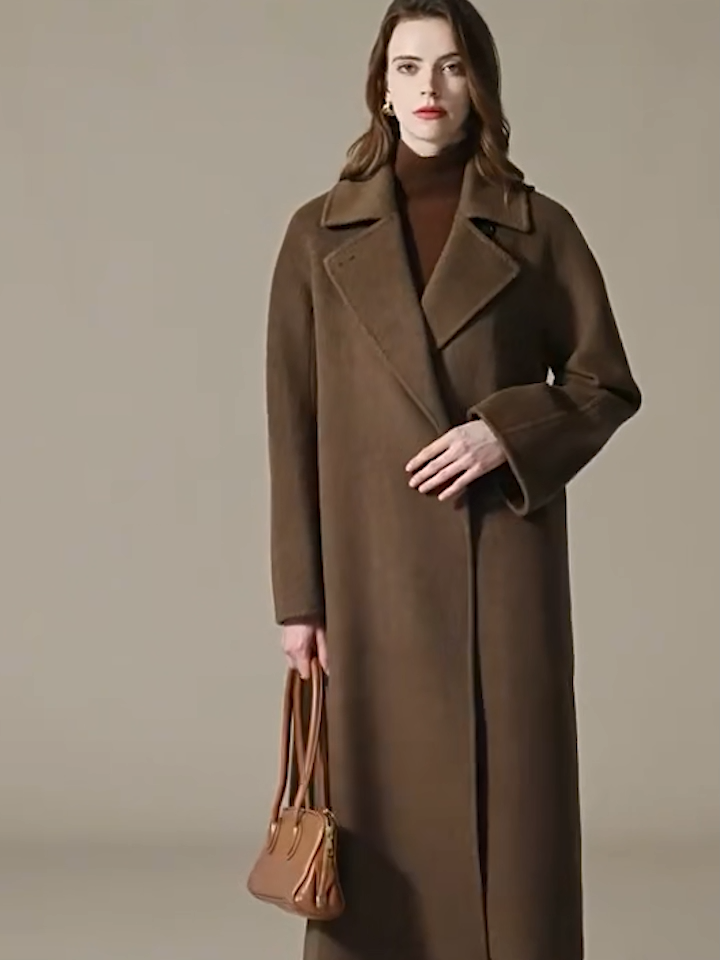 Video showcasing a Women's Long camel hair coat in Gobi Haze color, featuring a pointed collar and princess seams. — From Borcelleclothes.