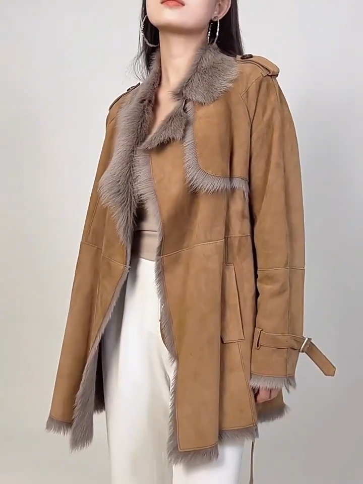 Video showcasing a Women's double-faced goatskin coat in Gold Ransom, with a storm flap, notch lapels, and self-tied belt. — From Borcelleclothes.