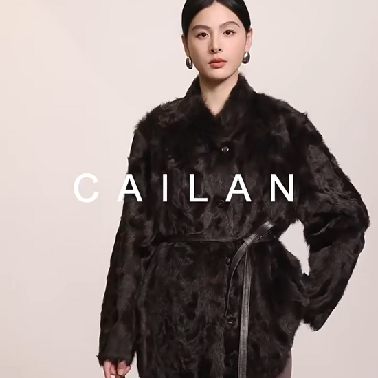 Video showcasing a Women's V-shaped Henna Glow shearling coat made of double-faced Xiaohu sheepskin, with heat-sculpted waves and luminous wool — From Borcelleclothes.