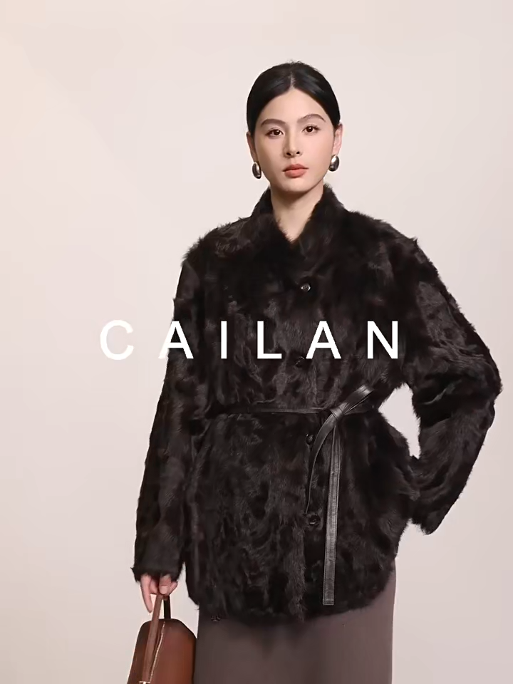 Video showcasing a Women's V-shaped Henna Glow shearling coat made of double-faced Xiaohu sheepskin, with heat-sculpted waves and luminous wool — From Borcelleclothes.