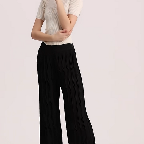 Video showcasing a Women's wide-leg Mulberry Silk Jacquard trousers in Hide-and-Seek featuring an asymmetrical high-low waist yoke with right insert and groups of vertical triple tucks. — From Borcelleclothes.