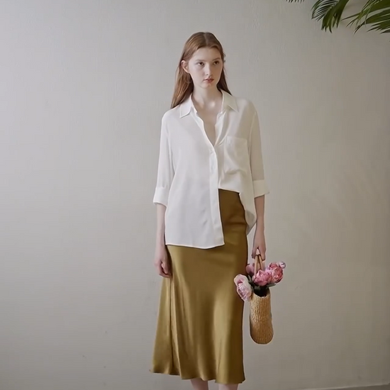 Video showcasing a Women's mid-length A-line silk skirt in Himalaya tone with ribbed waistline and invisible side zipper, crafted from 22 Momme Mulberry silk. From Borcelleclothes.
