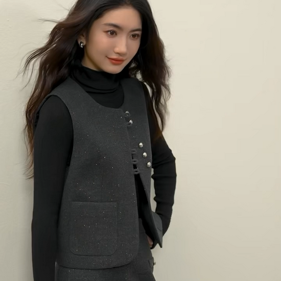 Video showcasing a Women's three-piece ensemble in knit (Syncopation color) and silver-lurex wool blend (Improvisation color). Features structural exposed seams, a single-breasted vest with syncopated button grouping, and a midi skirt. — From Borcelleclothes.
