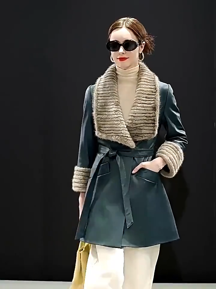 Video showcasing a Women's Sheepskin coat in Independence color, with rectangular striped mink collar, extended cuffs, wide welt pockets, and a self-tie belt. — From Borcelleclothes.