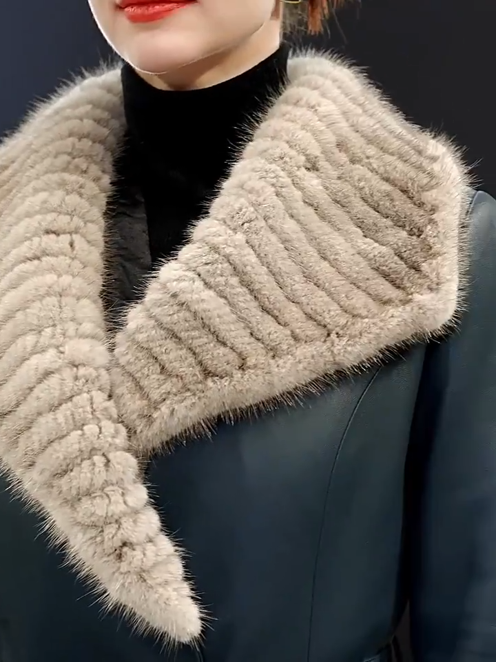Video showcasing a Women's Mid-calf sheepskin coat in Independence and Onyx colors, with wide striped mink collar extending to the arms, leather snap cuffs, and fur-tipped belt — From Borcelleclothes.