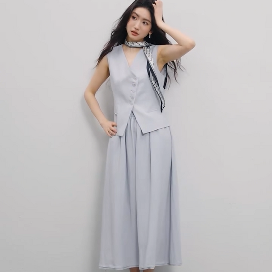 Video showcasing a Women's two-piece set: sleeveless asymmetrical vest with tonal buttons and a flared midi skirt with an elasticated waistband. Shown in Lavender Mist and Muted Chord colors. — From Borcelleclothes.