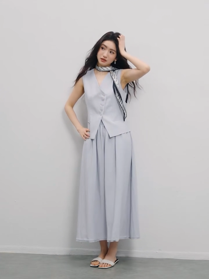 Video showcasing a Women's two-piece set: sleeveless asymmetrical vest with tonal buttons and a flared midi skirt with an elasticated waistband. Shown in Lavender Mist and Muted Chord colors. — From Borcelleclothes.