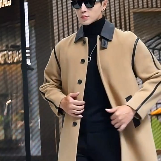 Video showcasing a Men’s urban leather-trim wool coat in Lion, with pointed leather collar, raglan sleeves, and graphic seam detailing — From Borcelleclothes.