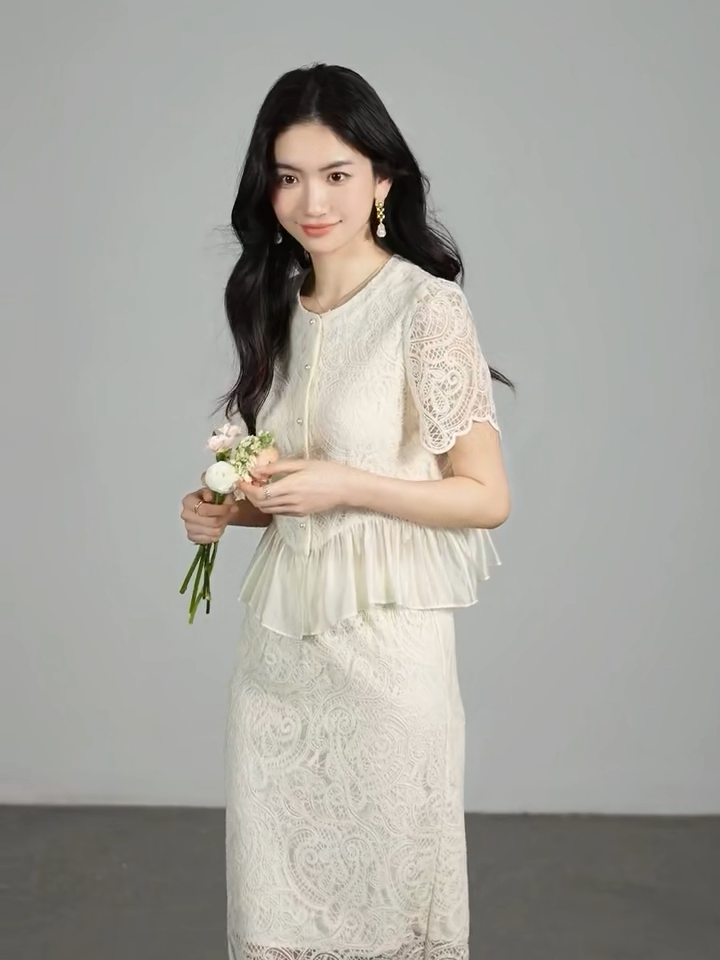 Video showcasing a Women's two-piece set in Memory Overload color, featuring a lace-embroidered vest-style top with a transparent peplum and a matching midi pencil skirt with a back vent. — From Borcelleclothes.