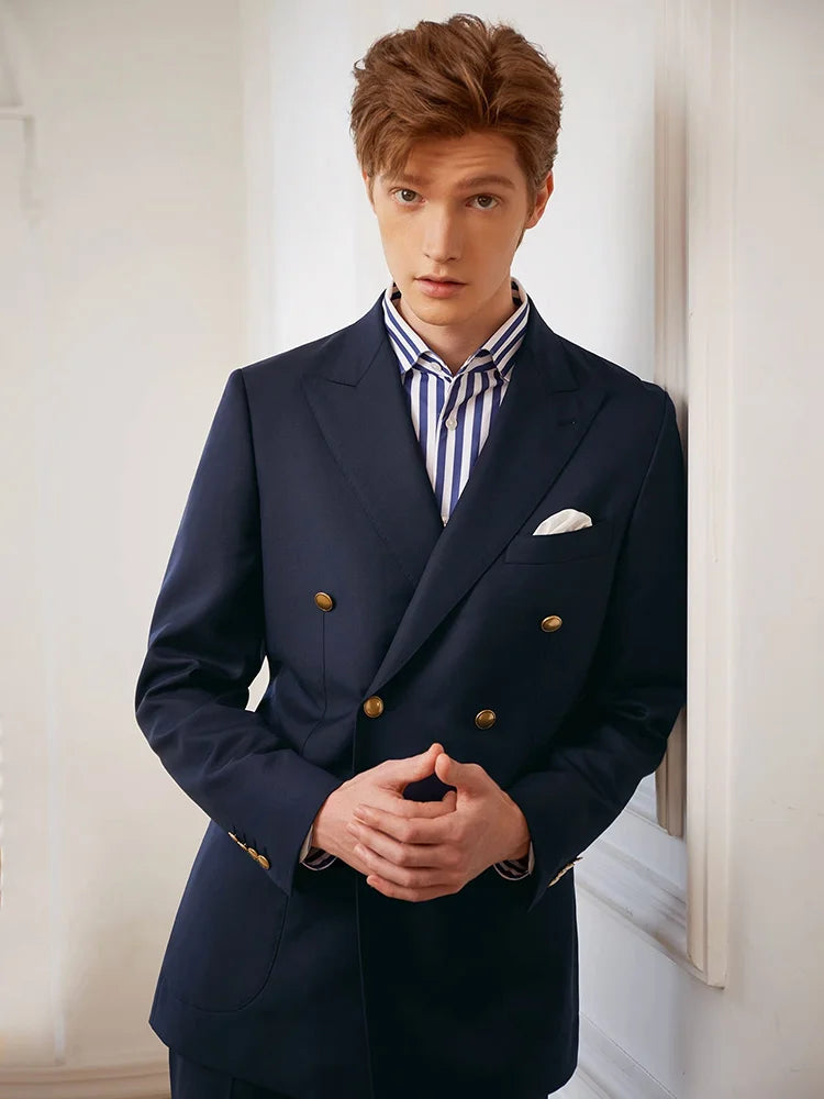 Video showcasing a Men's VBC Navy Blue Wool Suit with Brass Accents featuring a double-breasted blazer with peaked lapels, bold convex brass buttons, patch pockets, and slim-cut pants, crafted from 100% wool for a timeless and sophisticated look. — From Borcelleclothes.