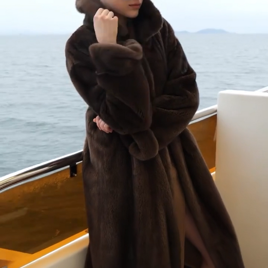 Video showcasing a Women’s minimalist full-length mink fur coat with clean silhouette, hidden hook closure, and seamless surface — shown in Mirage of Marron and White Echo. — From Borcelleclothes.