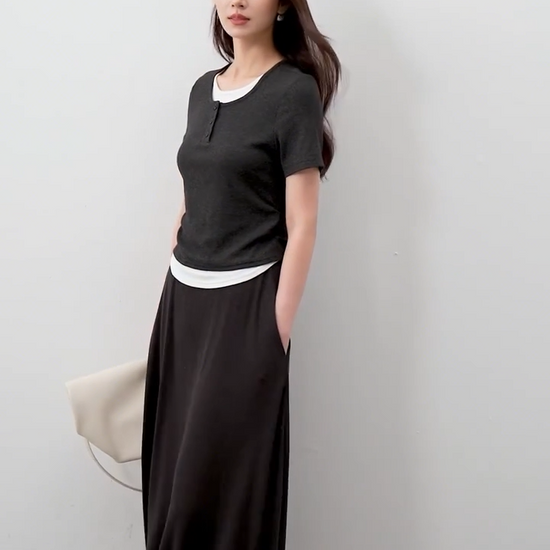 Video showcasing a Women's ribbed knit coordinates in Mojo color, featuring a slim-fit buttoned top with white contrast inserts and a matching flared midi skirt. — From Borcelleclothes.