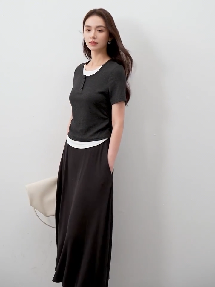 Video showcasing a Women's ribbed knit coordinates in Mojo color, featuring a slim-fit buttoned top with white contrast inserts and a matching flared midi skirt. — From Borcelleclothes.