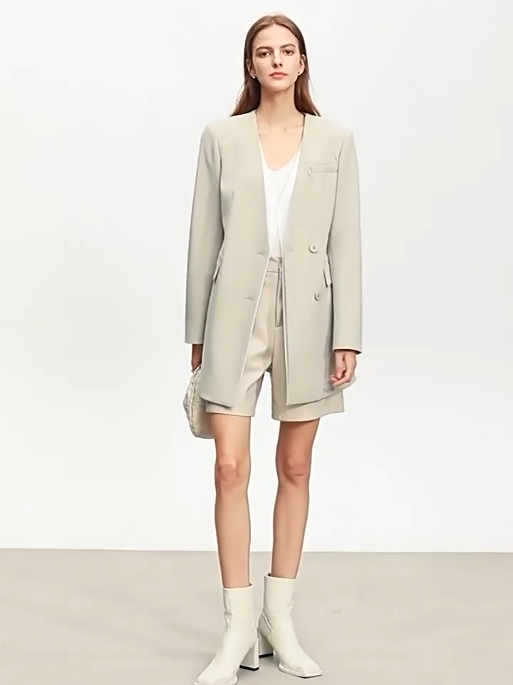 Video showcasing a Women’s Moon Mist wrap blazer with deep wrap, belt, and angled layered detail creating a quiet illusion of retro grace. From Borcelleclothes.
