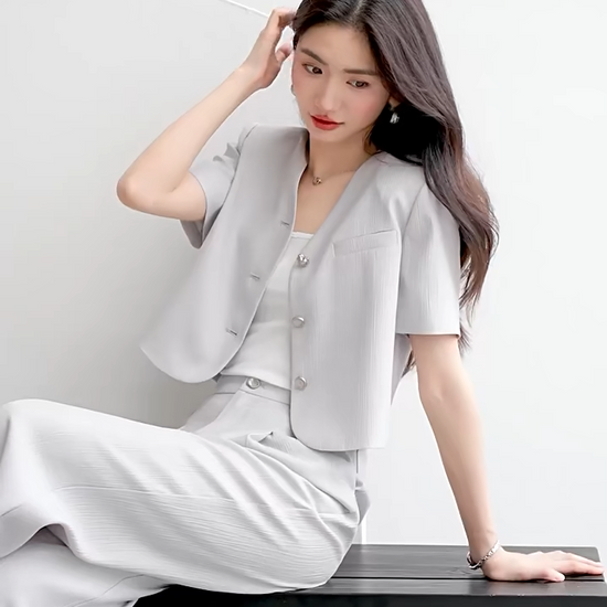 Video showcasing a Women's crinkled viscose suit in Named by Frost color featuring cropped short-sleeve jacket with no collar and matching wide-leg pleated trousers. — From Borcelleclothes.