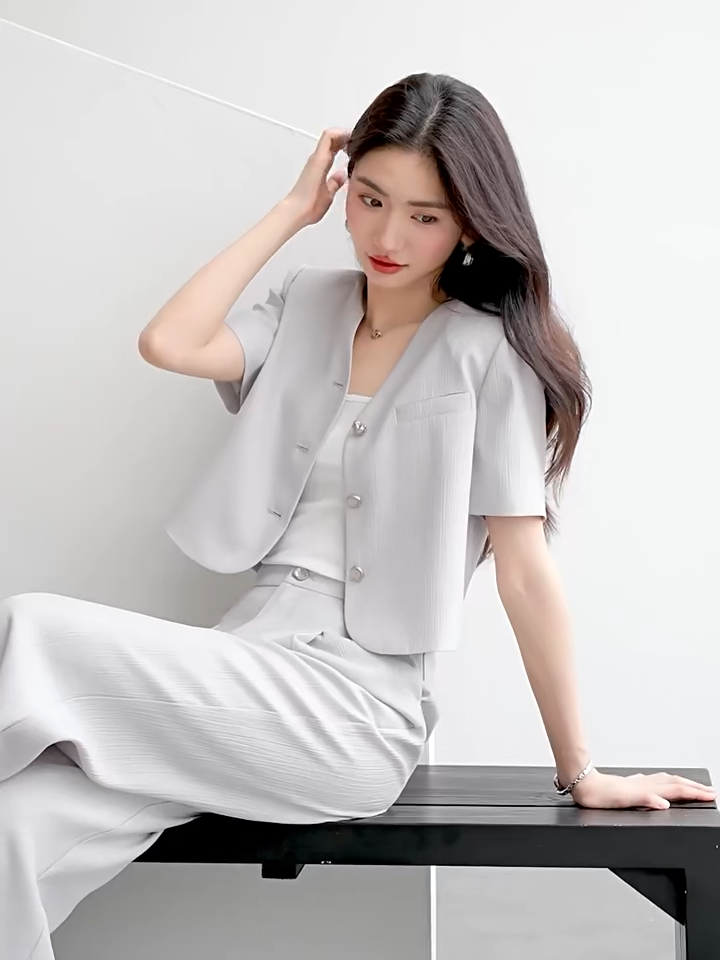Video showcasing a Women's crinkled viscose suit in Named by Frost color featuring cropped short-sleeve jacket with no collar and matching wide-leg pleated trousers. — From Borcelleclothes.