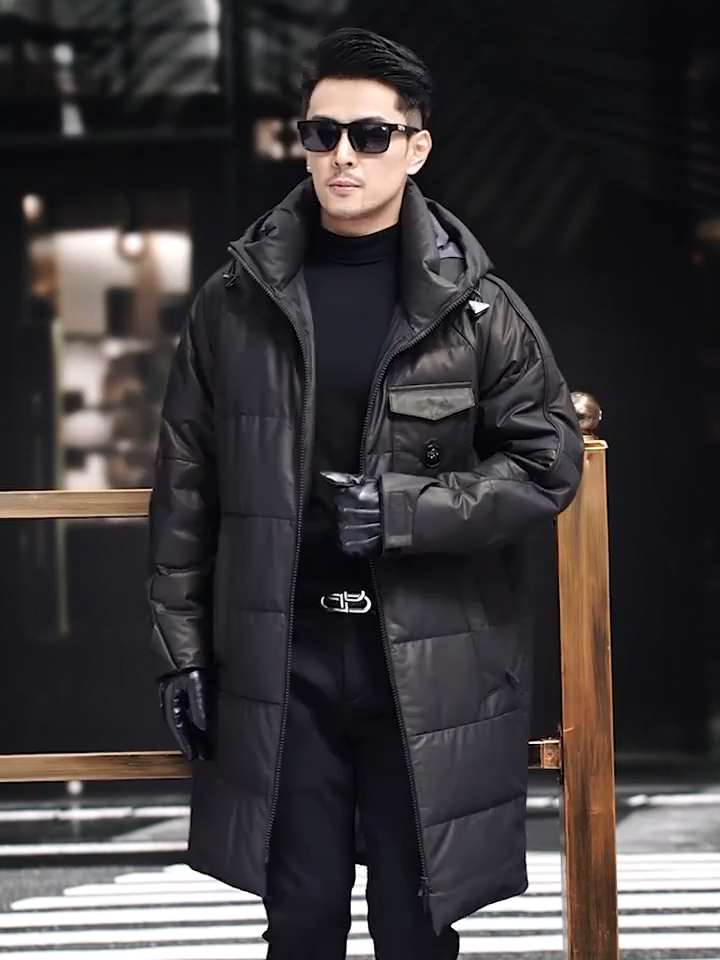 Video showcasing a Men’s cowhide down coat in Onyx color, with raglan sleeves and sculpted hood-collar design. From Borcelleclothes.
