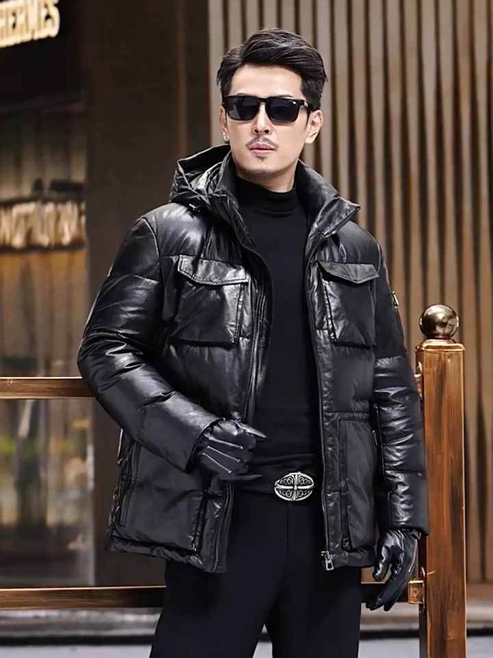 Video showcasing a Men’s goatskin down jacket in Onyx with four cargo pockets, detachable hood, stand collar, and front zip closure. Slightly glossy finish. From Borcelleclothes.