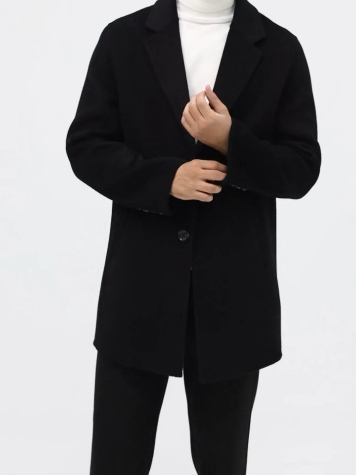 Video showcasing a Men’s mid-length double-faced wool coat in Onyx with notch lapels and two-button closure. From Borcelleclothes.