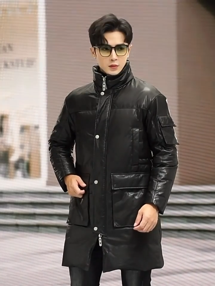 Video showcasing a Men’s structured cowhide coat in Onyx, with cargo pockets, stand collar, and two-way zipper. Goose down insulation. From Borcelleclothes.