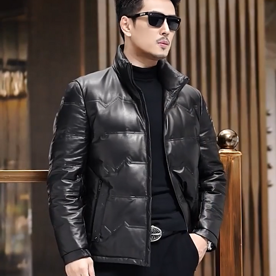 Video showcasing a Men's cowhide leather jacket featuring embossed zigzag front detail with lettering, styled with a stand collar and side pockets. - From Borcelleclothes.