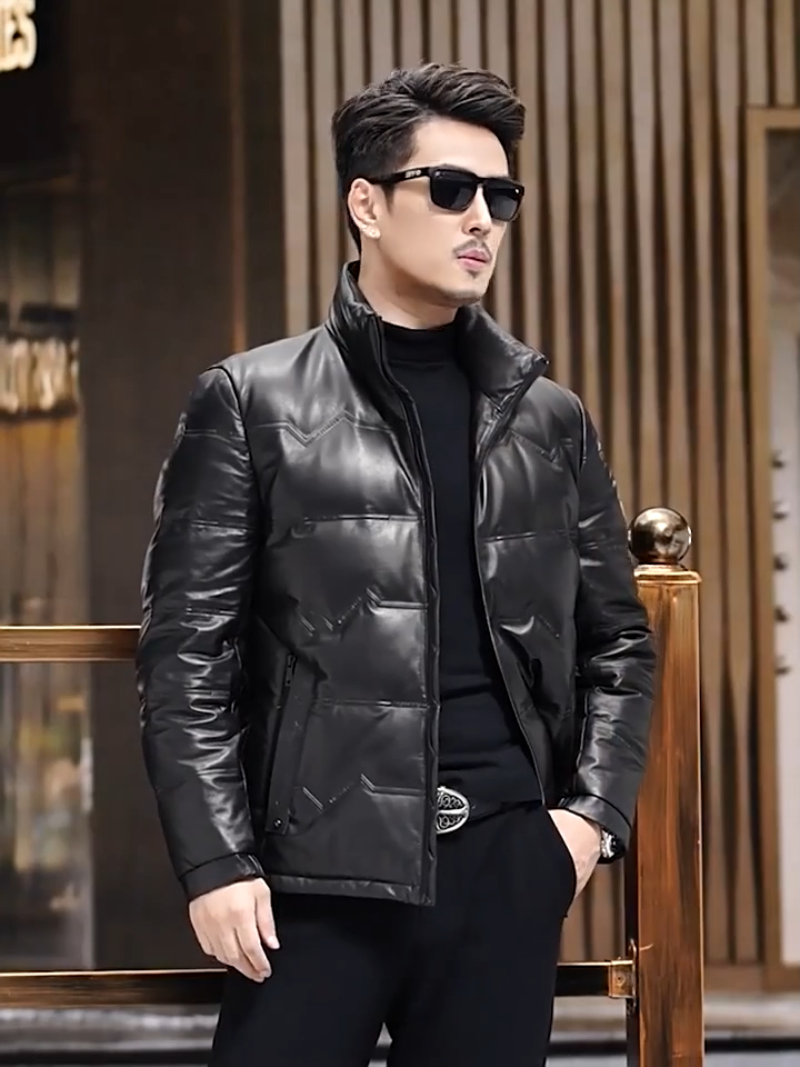 Video showcasing a Men's cowhide leather jacket featuring embossed zigzag front detail with lettering, styled with a stand collar and side pockets. - From Borcelleclothes.