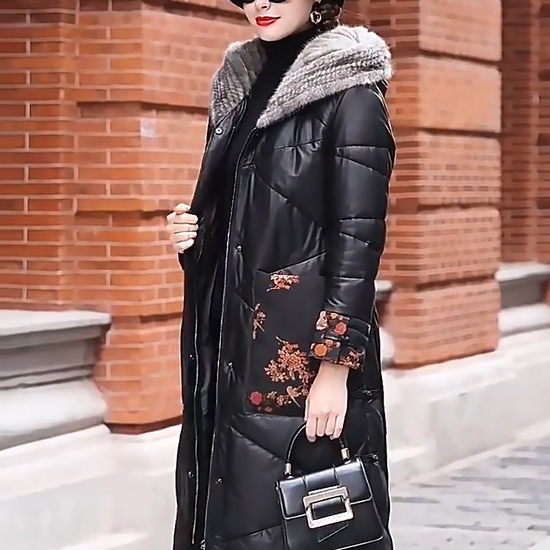 Video showcasing a Women's sheepskin coat in Onyx with mink-lined hood, printed floral leather cuffs and pockets, tonal zigzag quilting, and decorative knot closures — From Borcelleclothes.