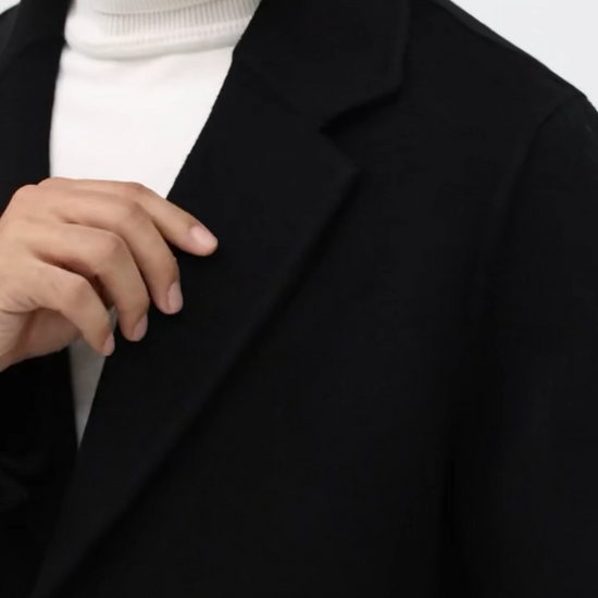 Video showcasing a Men’s mid-length double-faced wool coat in Onyx with notch lapels and two-button closure. From Borcelleclothes.