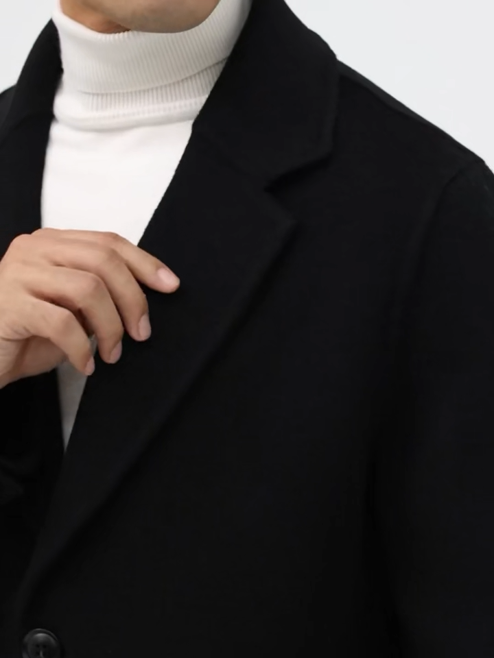 Video showcasing a Men’s mid-length double-faced wool coat in Onyx with notch lapels and two-button closure. From Borcelleclothes.