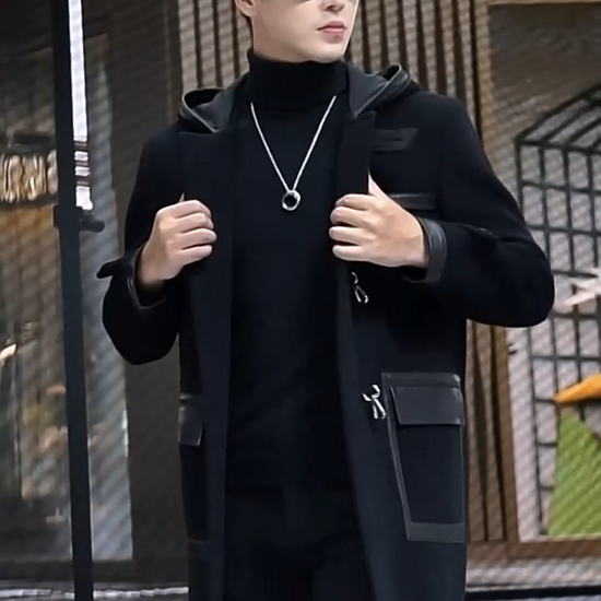 Video showcasing a Men’s hybrid wool-leather coat in Onyx, with hood, leather overlays, and distinctive swivel-clasp closures. From Borcelleclothes.