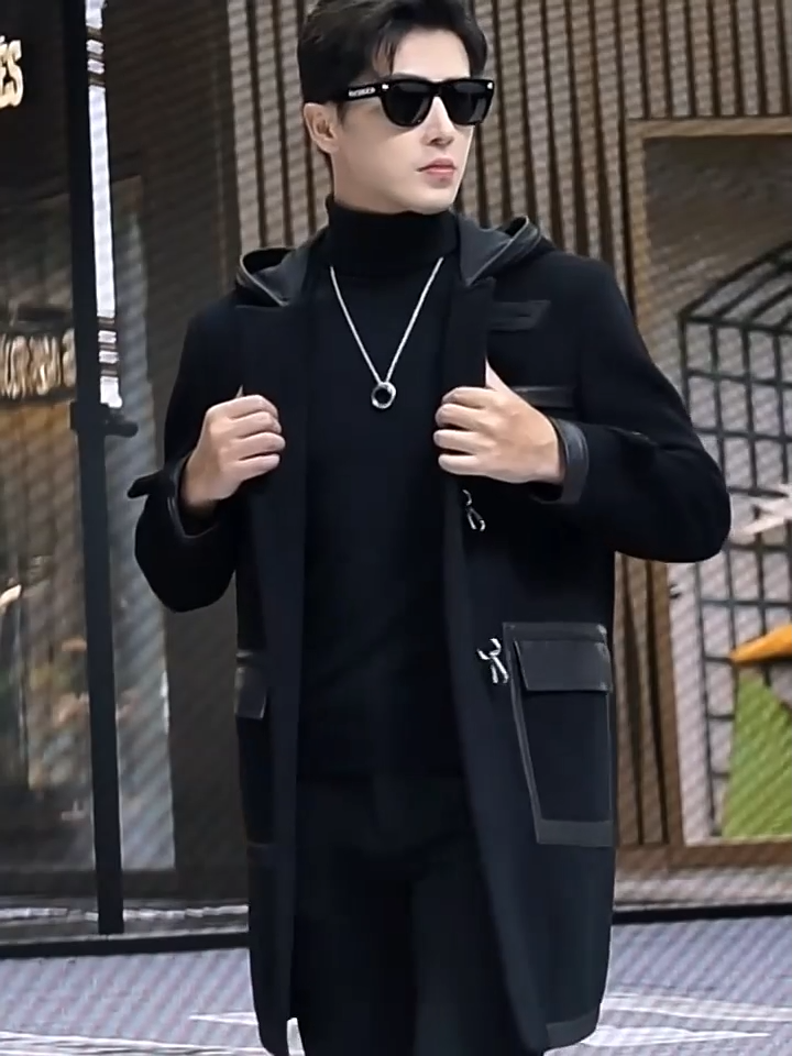 Video showcasing a Men’s hybrid wool-leather coat in Onyx, with hood, leather overlays, and distinctive swivel-clasp closures. From Borcelleclothes.