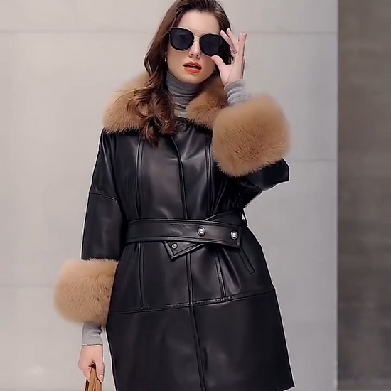 Video showcasing a Women’s sheepskin coat in Light French Beige and Onyx colors, with fox fur collar and kimono sleeves, belted waist, and thigh-length silhouette. — From Borcelleclothes.