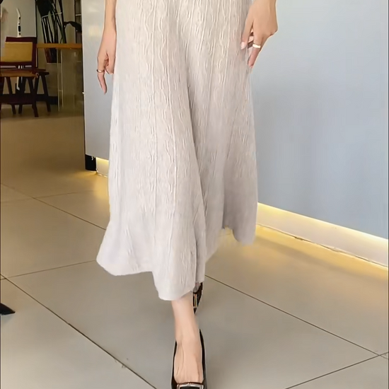 Video showcasing a Women's A-line merino wool skirt in Pale Silver, with vertical and wave-textured knit, mid-calf length, in soft premium fabric — From Borcelleclothes.