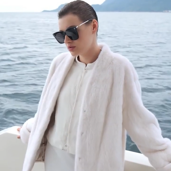Video showcasing a Women's sheared mink coat with V-neckline and turned-back cuffs, relaxed straight silhouette, shown in Pale Reverie and Trace of Clove colors — From Borcelleclothes.
