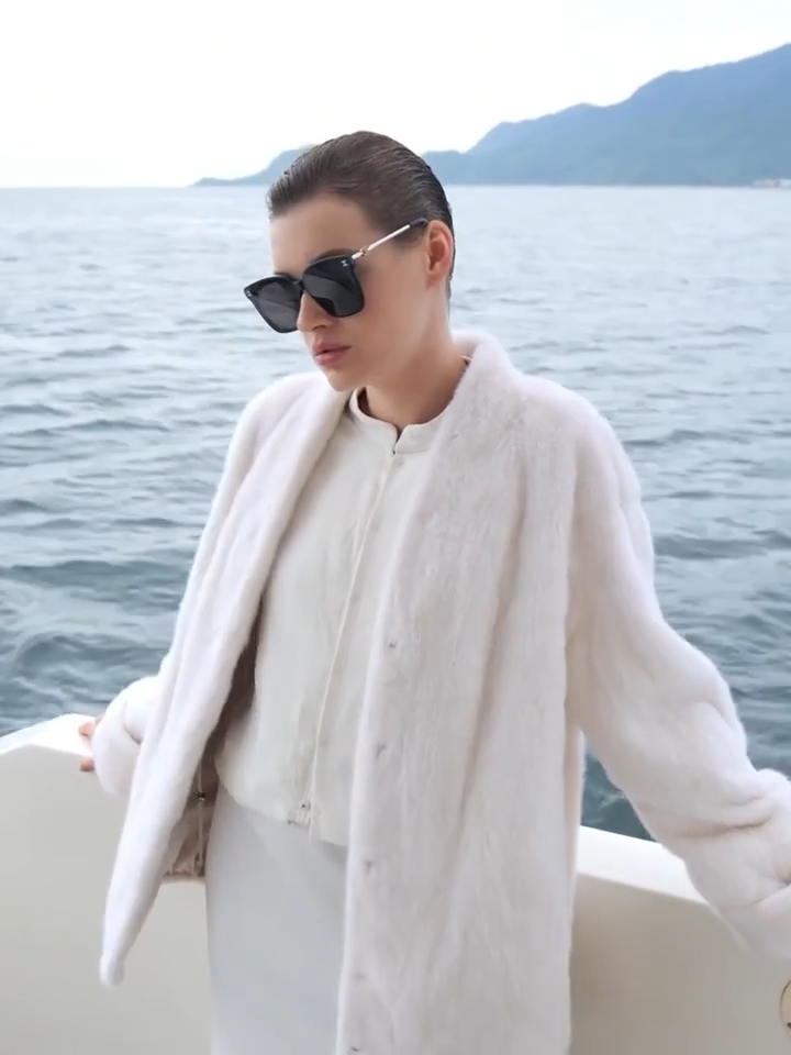 Video showcasing a Women's sheared mink coat with V-neckline and turned-back cuffs, relaxed straight silhouette, shown in Pale Reverie and Trace of Clove colors — From Borcelleclothes.