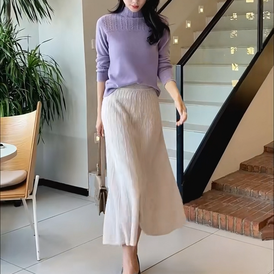Video showcasing a Women's A-line merino wool skirt in Pale Silver, with vertical and wave-textured knit, mid-calf length, in soft premium fabric — From Borcelleclothes.