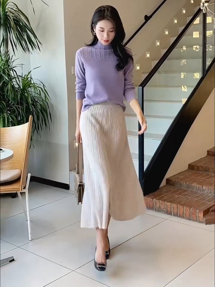 Video showcasing a Women's A-line merino wool skirt in Pale Silver, with vertical and wave-textured knit, mid-calf length, in soft premium fabric — From Borcelleclothes.