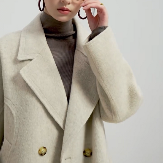 Video showcasing a Women's Alashan wool coat in Peace of Mind, showcasing the seamless double-sided hand-stitching and sculpted back yoke silhouette. — From Borcelleclothes.