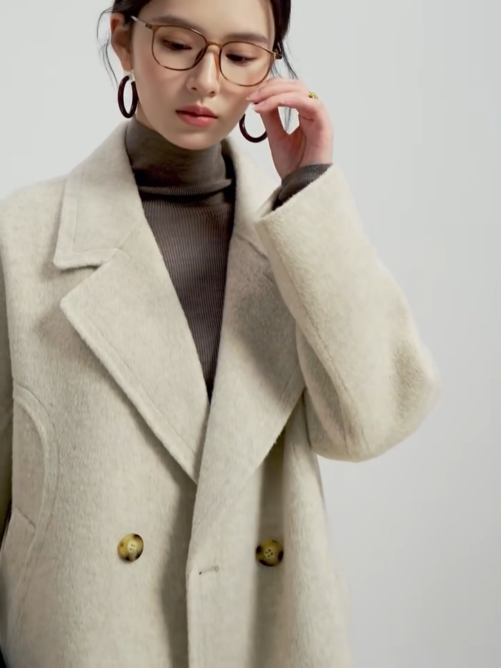 Video showcasing a Women's Alashan wool coat in Peace of Mind, showcasing the seamless double-sided hand-stitching and sculpted back yoke silhouette. — From Borcelleclothes.